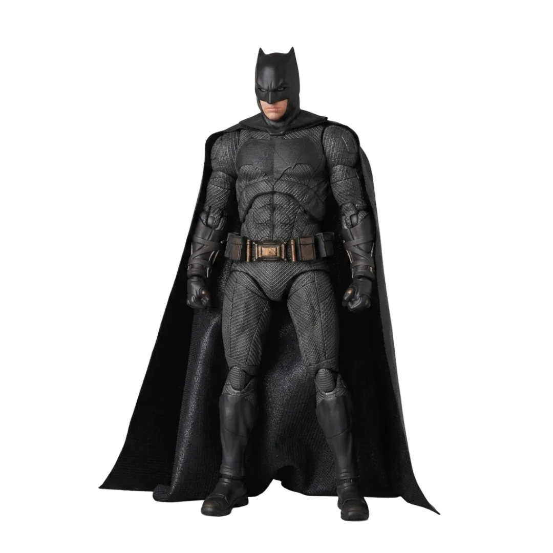 A Batman action figure or collectible statue in a full-body pose, wearing a textured black suit with a flowing black cape, standing against a plain light gray studio background.
