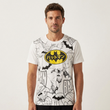 A man wearing a white short-sleeve t-shirt with a black and yellow Batman graphic print, featuring the classic Batman logo with Japanese text on the chest.