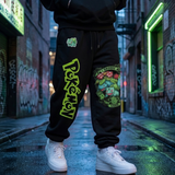 Black sweatpants with a large green and yellow Pokemon logo on one leg and a Squirtle graphic on the other, worn by a person standing in a wet urban alleyway.