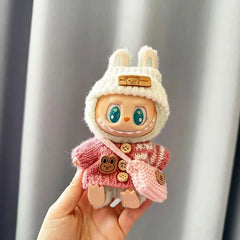 Mini Labubu plush toy in pink bunny-themed sweater.