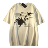 An oversized cream-colored t-shirt featuring a black spider graphic and text on the front, displayed flat against a white background.