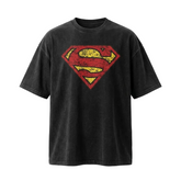 A black washed short-sleeve t-shirt featuring a distressed red and yellow Superman logo on the chest, displayed against a clean white background.