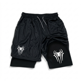 Black athletic mesh shorts with an integrated black liner underneath, featuring a white Venom-style spider logo on both legs and a gray drawstring, shown on a white background.