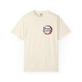 An off-white short-sleeve crewneck t-shirt featuring a circular 'Demon Slayer' graphic on the left chest, displayed against a solid white background.