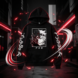 A black pullover hoodie with anime-style graphic prints on the front and sleeves, shown centered against a dark urban street background with red neon lights and motion blur effects.