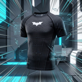 A black short-sleeve athletic compression shirt with a textured honeycomb pattern and a white Batman logo on the chest, displayed against a futuristic digital background with blue glowing lines and glass shards.