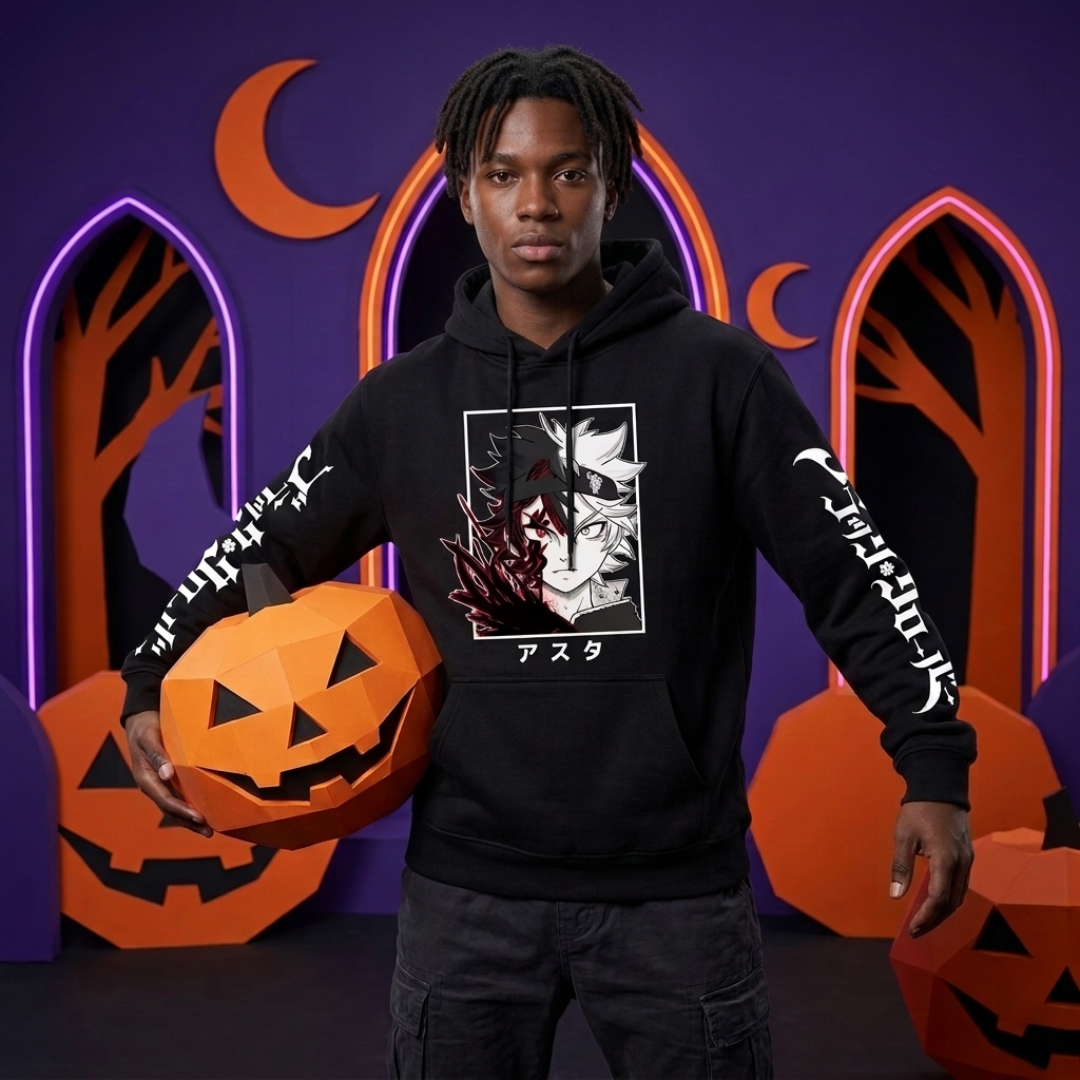 A man modeling a black graphic hoodie with Halloween-themed props, including orange jack-o'-lanterns, set against a purple background with neon arches and crescent moons.