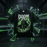 A black graphic t-shirt featuring the word 'DOOM' in distressed white letters above a dark, shadowy figure surrounded by glowing green energy effects. The shirt is displayed against a dark, industrial background with green neon lightning and shattered glass graphics.