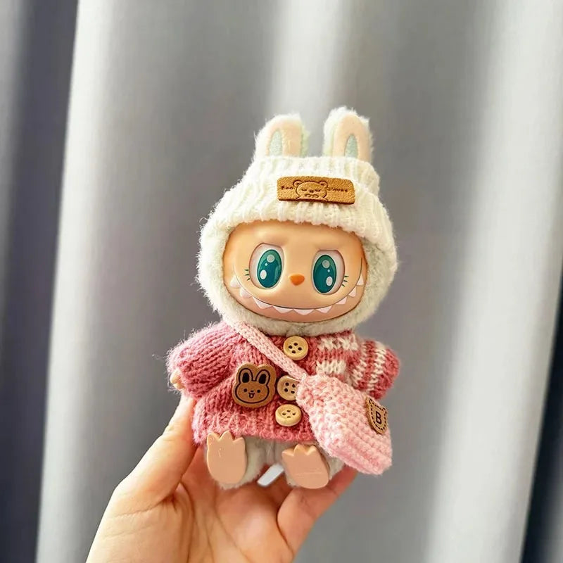 Mini Labubu plush toy in pink bunny-themed sweater.