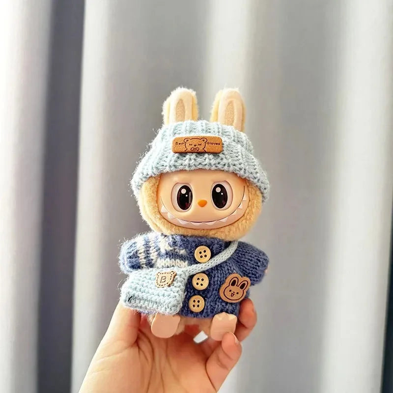 Mini Labubu plush toy in blue bunny-themed sweater.