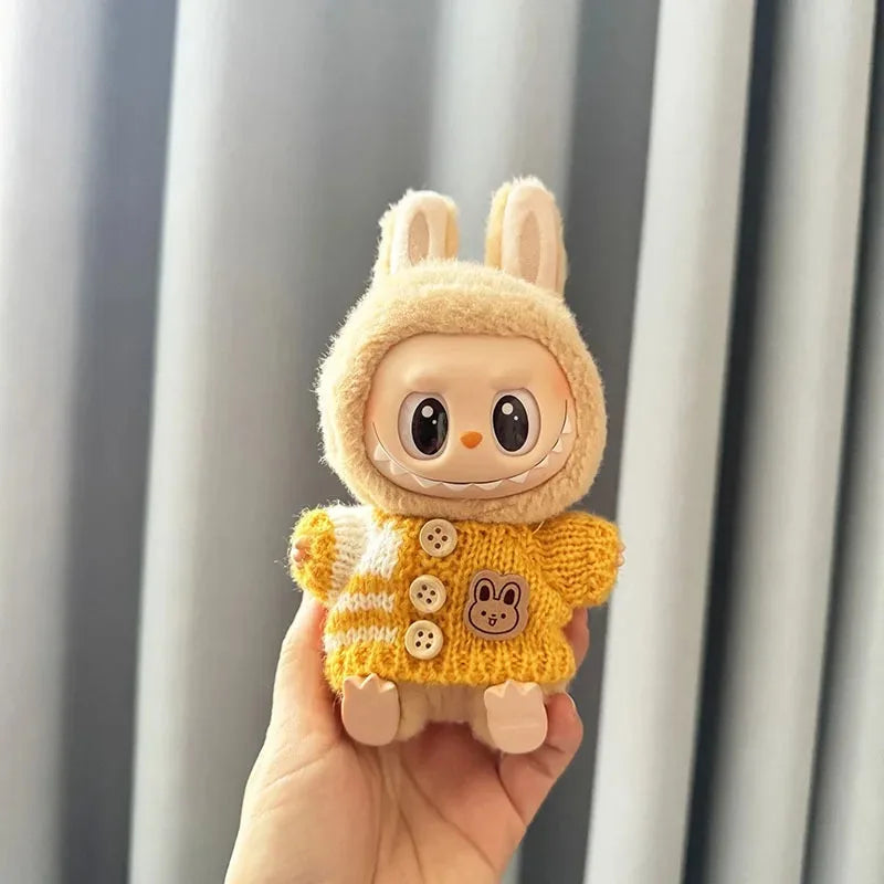 Mini Labubu plush toy in yellow bunny-themed sweater.