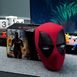 Red and black mask resembling a superhero design on a gray surface with a blurred background.