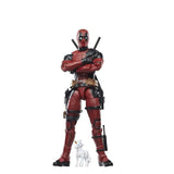 Action figure in a red and black costume with a white dog on a white background