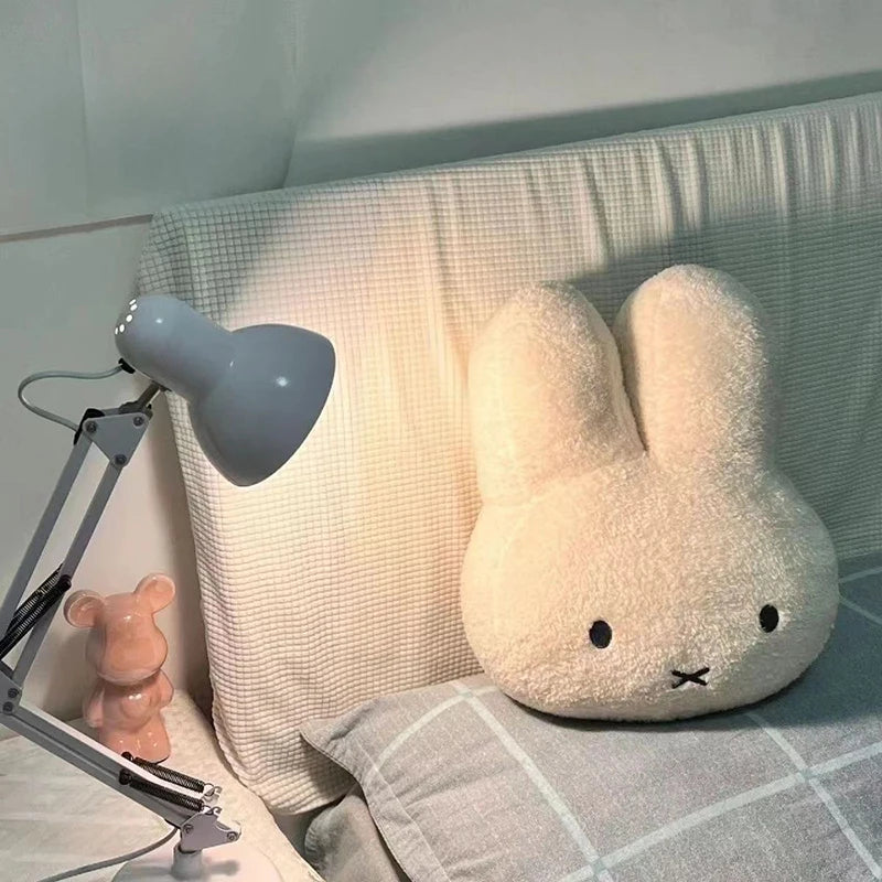 bunny plush toy next to desk lamp