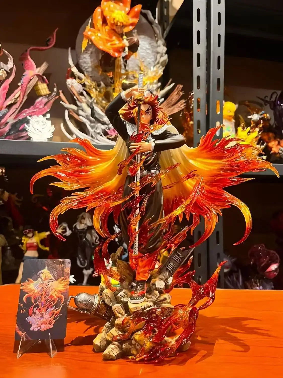Detailed figurine with fiery design on a stand, surrounded by other similar items.