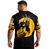 A man shown from the back wearing a black short-sleeve t-shirt with a large Wolverine graphic on the back and yellow sleeve panels with white text.