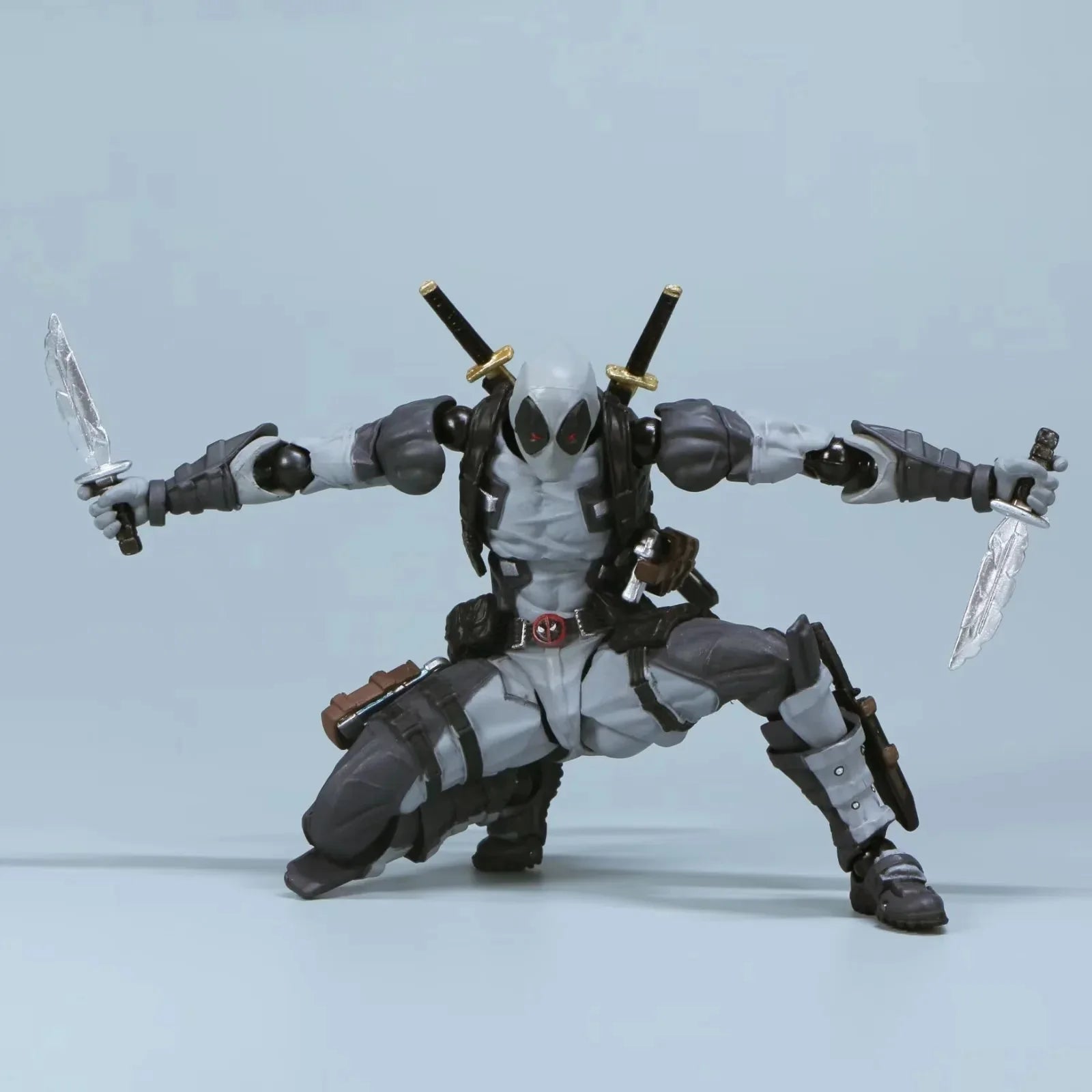 Action figure with multiple arms and weapons on a light gray background