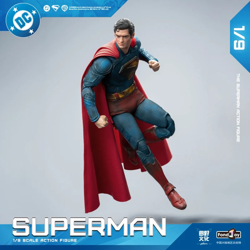 Superman action figure with red cape and blue suit on a gray background, featuring DC logo.