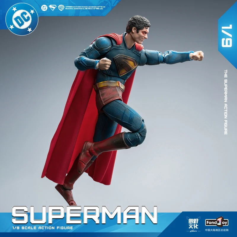 Superman action figure with red cape and blue suit on a gray background, featuring DC logo.