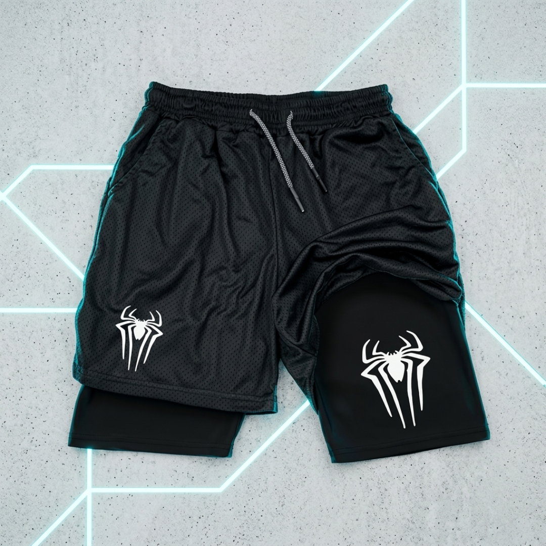 Black athletic shorts with a mesh texture, featuring a white spider logo on both legs and a black inner liner visible at the hem. The shorts are laid flat on a gray textured background with glowing neon geometric lines.