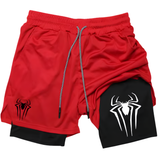 Red athletic shorts with a black inner layer, featuring a black spider logo on the left leg and a large white spider logo on the right leg, with a gray drawstring.