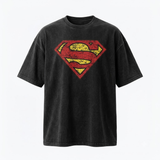 A black washed short-sleeve t-shirt featuring a distressed red and yellow Superman logo on the chest, displayed against a clean white background.