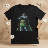 A black short-sleeve t-shirt featuring a graphic print of the Marvel character Doctor Doom, styled on a beige background with decorative cotton bolls and dried leaves.