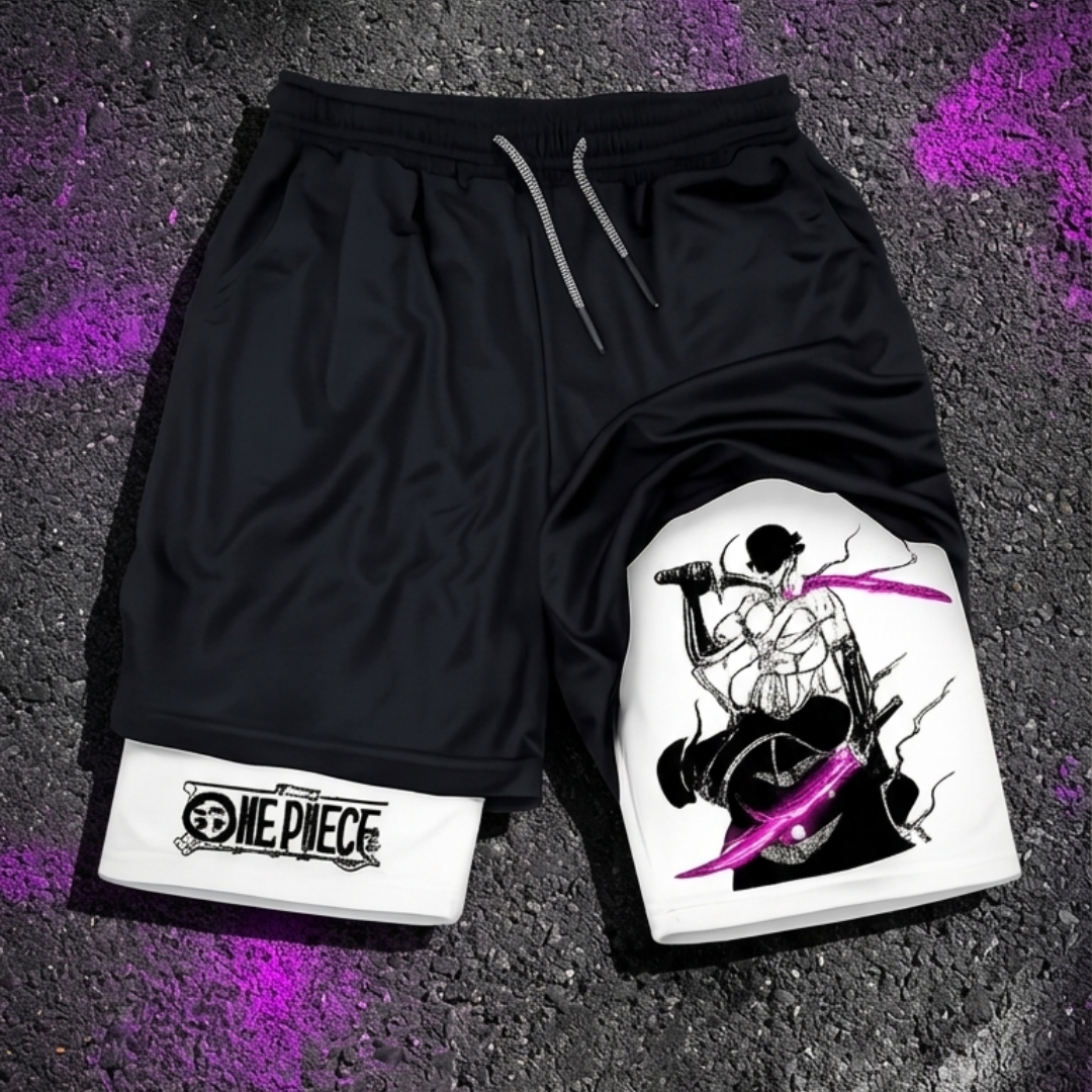 Black athletic shorts with a white lower leg panel featuring One Piece character artwork and a One Piece logo patch, laid flat on a dark textured surface with purple spray-paint accents.